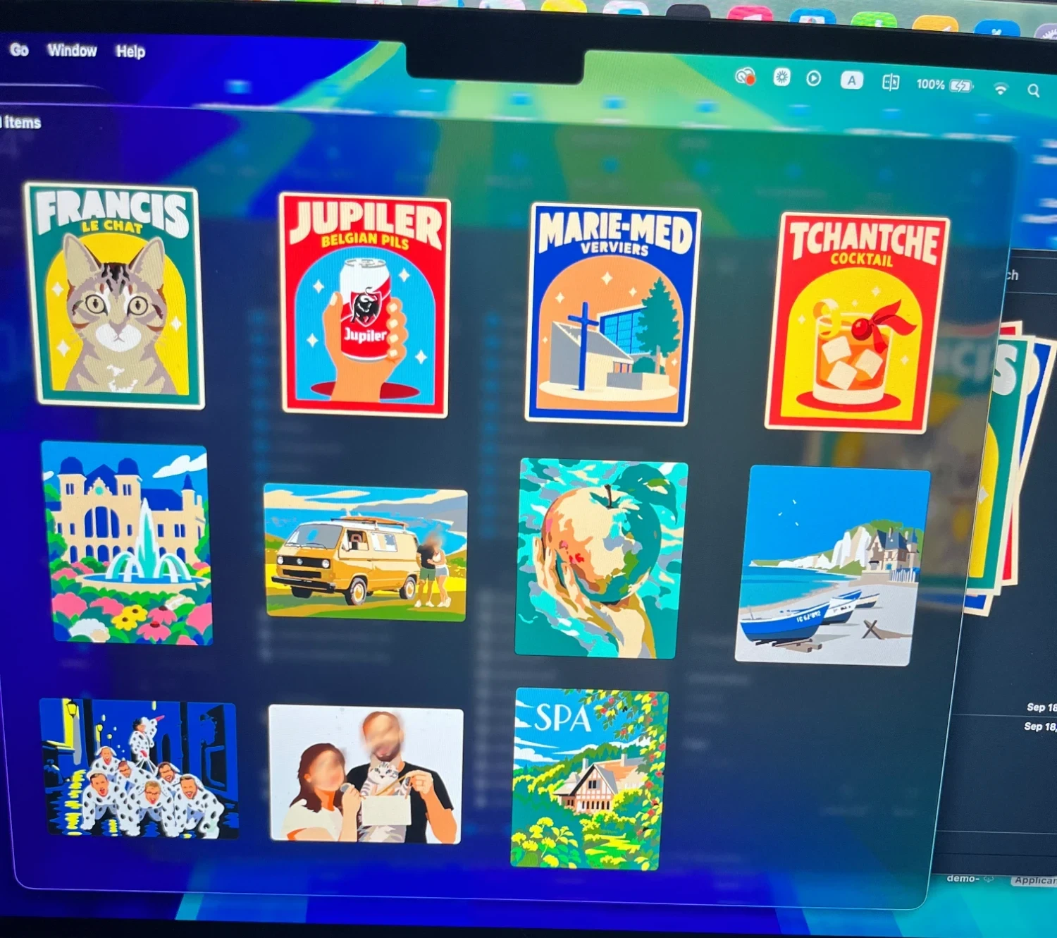 A laptop screen showing eleven poster thumbnails: a cat named Francis, a Jupiler can, a building in Verviers, a cocktail, a palace with a fountain, a yellow van, a hand holding an apple, the beach at Yport, a group in dalmatian costumes, a couple with a cat, and the town of Spa.